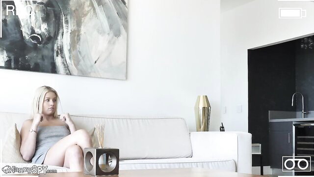 Blonde nanny in short dress sits legs spread on couch in Wet Nanny Taught Some Manners