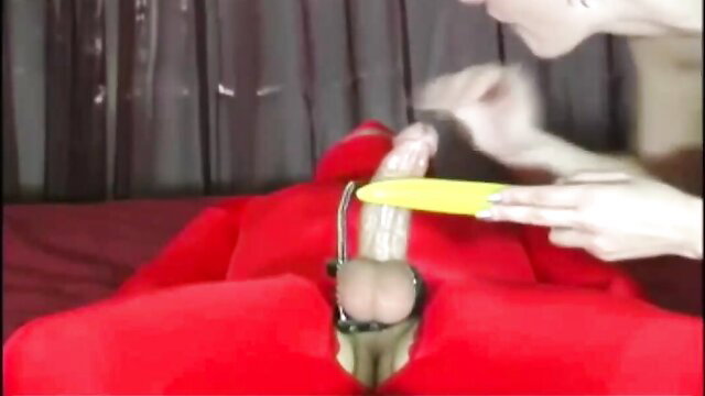 Woman teases bound cock with yellow dildo in red fetish pillow hump