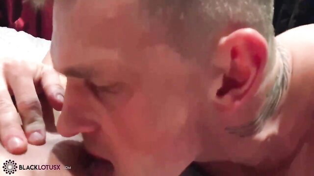 Bald muscular man with tattoos eating sultry slit closeup