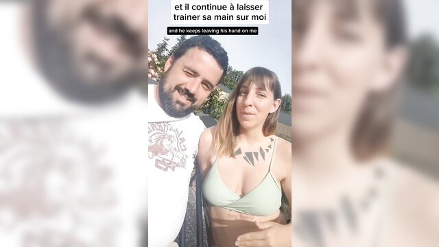 Tattooed brunette in green bra with man keeping hand on her, amateur couple tease