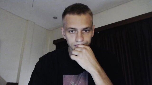 Handsome young gay guy with buzzcut, finger in mouth, teasing closeup