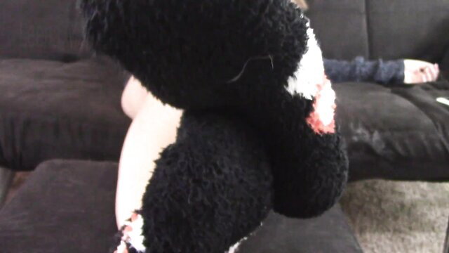 Leena Mae teases in black fuzzy socks, ignoring on couch