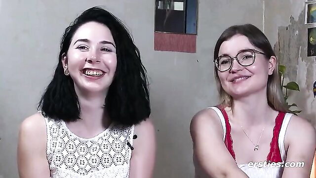 Two young girlfriends smiling in lingerie before hot strap-on sex