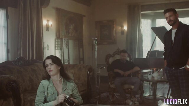 Octavia Red behind the scenes in green dress with men