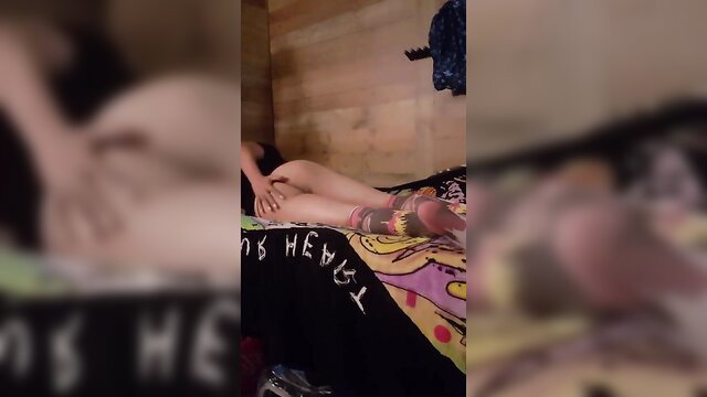 Jessithesissyxo teases in colorful stockings on bed in Sissy Dreams