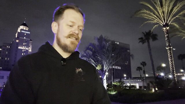 Bearded man in hoodie at night by LA palms - 23andMe Tales Pt IV