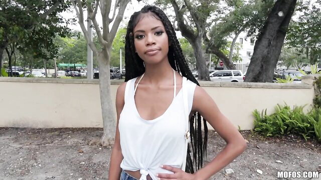 Hot ebony teen seductress in white tank top and shorts outdoors