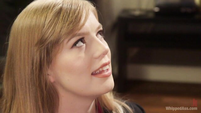 Blonde office boss smirks in kinky lesbian BDSM scene