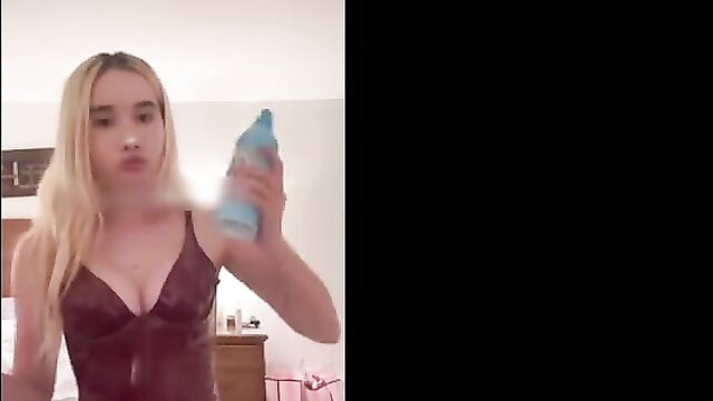 Lil Tay in tight burgundy lingerie holding blue whipped cream bottle