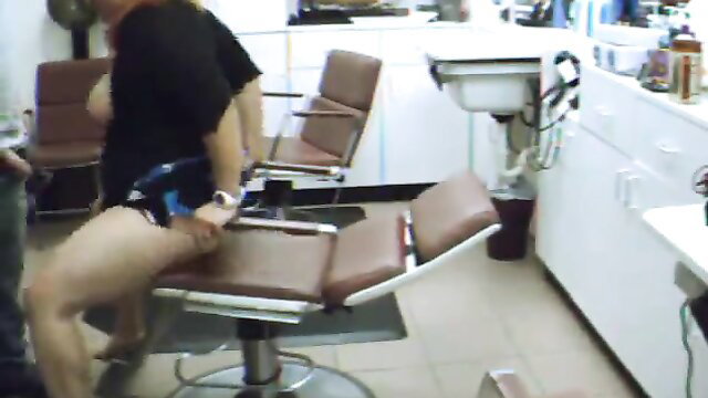 Busty woman fucked by man in salon chair