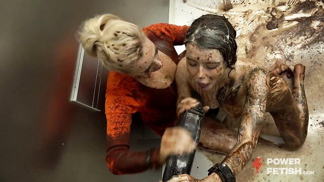 Blonde domme forces mud-covered sub to suck huge dildo in Eden 2 fetish scene