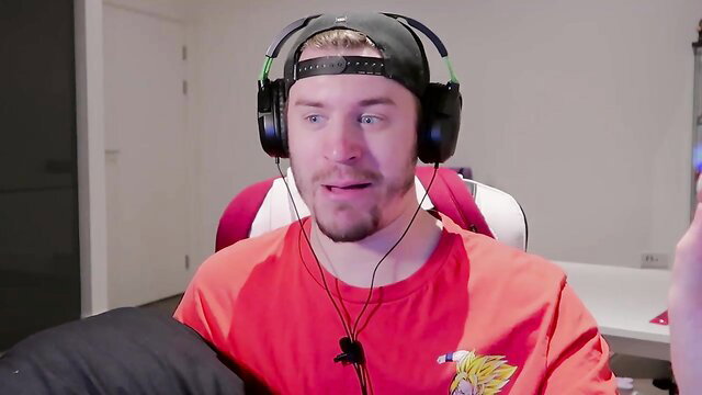 Guy in orange Goku shirt and headset watches horny catgirls pillow fight