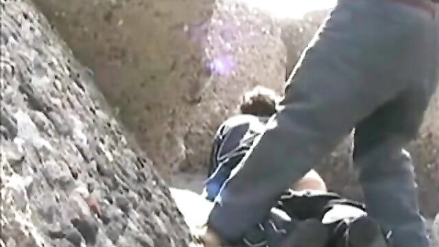 Outdoor cave sex: woman fucked doggystyle by man near beach