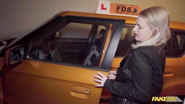 Blonde teen Kristy Waterfall in black suit at driving lesson