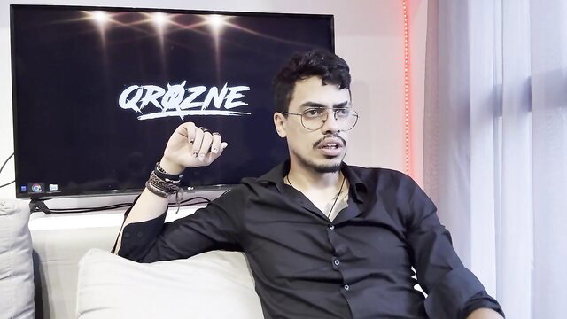 Curly-haired Latino man in glasses on Crazone podcast EP13 haters talk