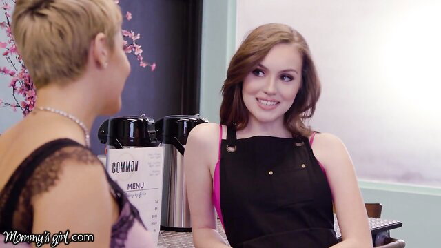 Ryan Keely in pink top black apron smiles at hot blonde MILF