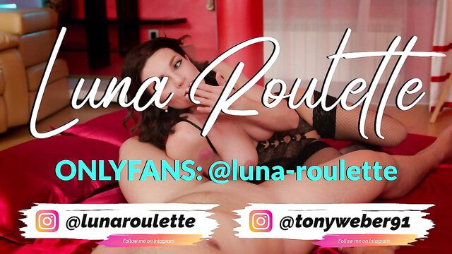 Luna Roulette in black lingerie, seductive pose on bed