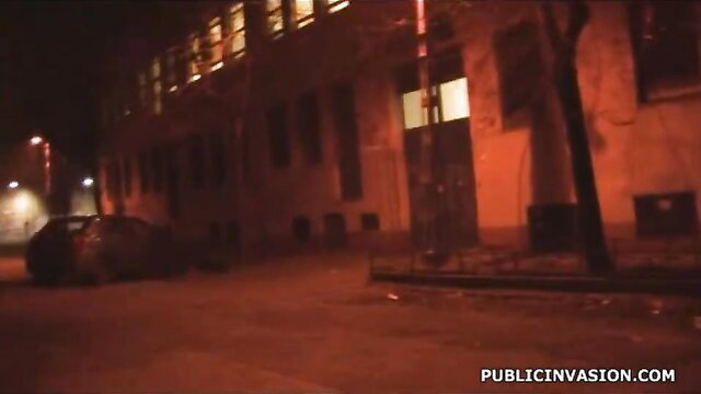 Night street scene with parked car outside lit building, big tits vixen vibe
