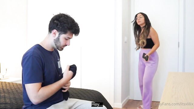 Hot Latina teen in pink sweats teases guy holding black sock on bed