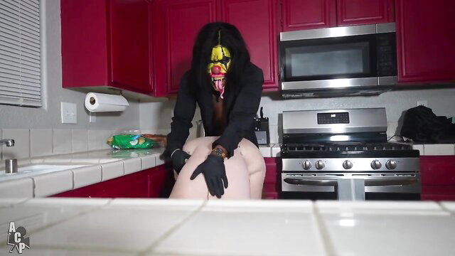 Horny black housewife in evil clown mask bends over kitchen counter