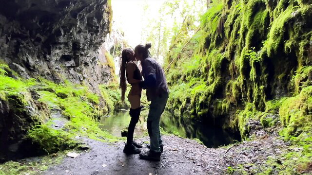 Implantboy couple kissing passionately in lush green cave, hot outdoor makeout