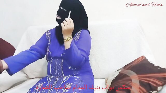 Hoda veiled Arab in blue abaya smoking hookah on couch