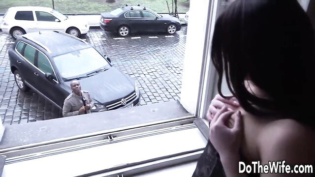 Caterine Love watches ebony dude from window in hotwife scene