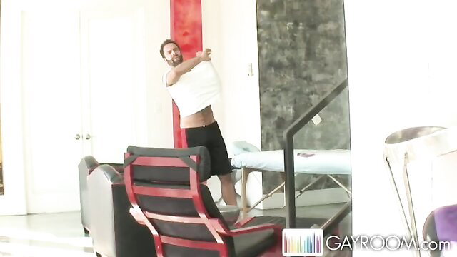 Hairy Dodger man stripping off white shirt exposing abs