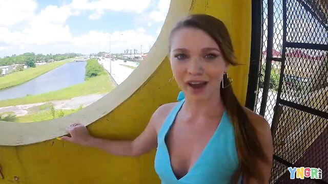 Mazy Myers in turquoise bikini top on balcony, smiling seductively