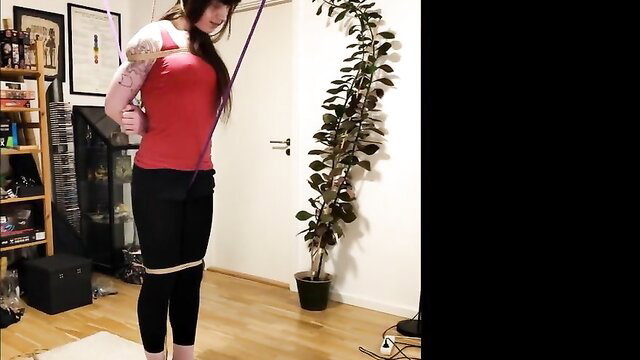 Nanayamichan tiptoes in red tank top, black leggings, crotch & neck rope predicament