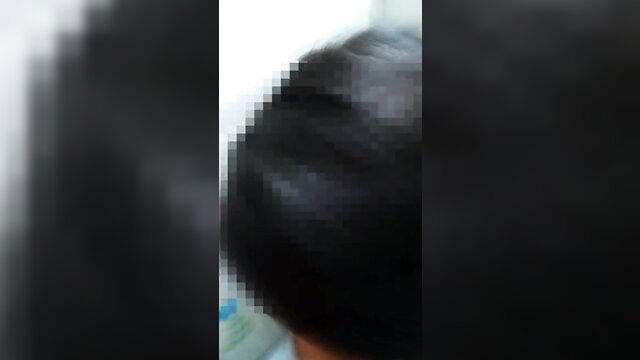 Blurry closeup of woman's black hair and man's profile in amateur piss kink video