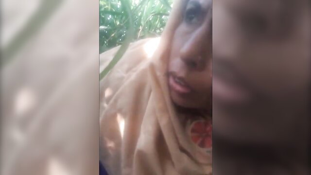 Village aunty in hijab with stranger in lush outdoor sex scene