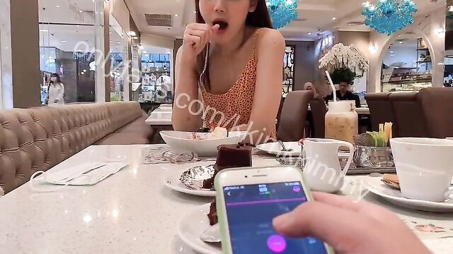 Asian babe orgasms hard in cafe from remote toy, friend controls