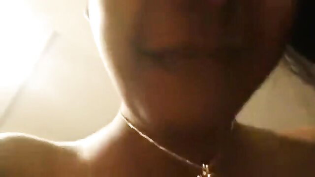Closeup of sexy Black woman's glossy lips and necklace in erotic tease