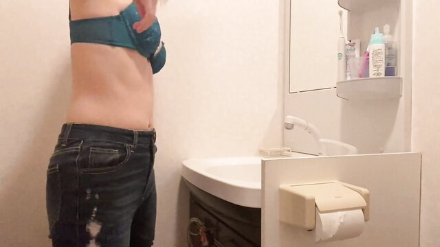 Japanese amateur Emu Yumi adjusting teal bra, slim waist in ripped jeans