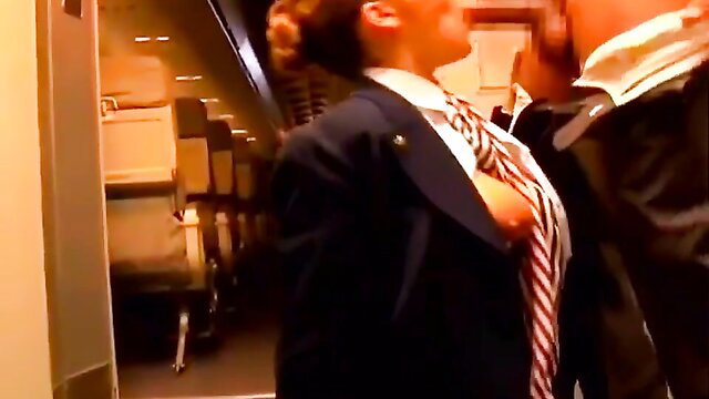 Natasha Nice in suit with tie pulled, exposed tits on plane