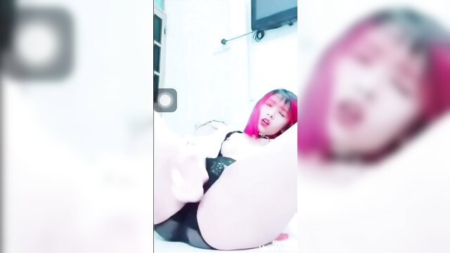 Pink-haired Asian babe in lingerie moans with sex toy, JAV style