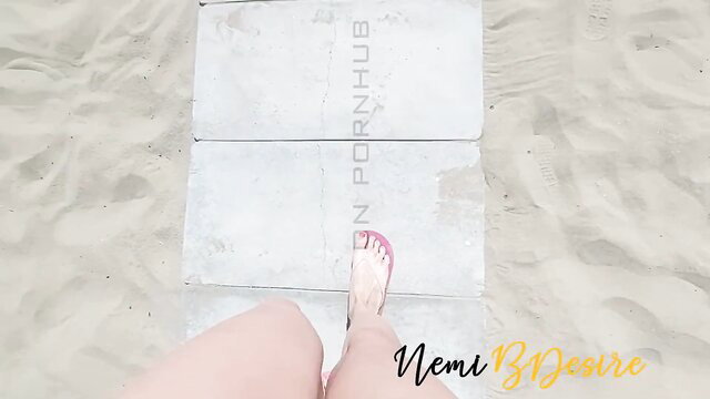 Nemi B Desir pink flip flop foot on beach tiles, sexy wife tease