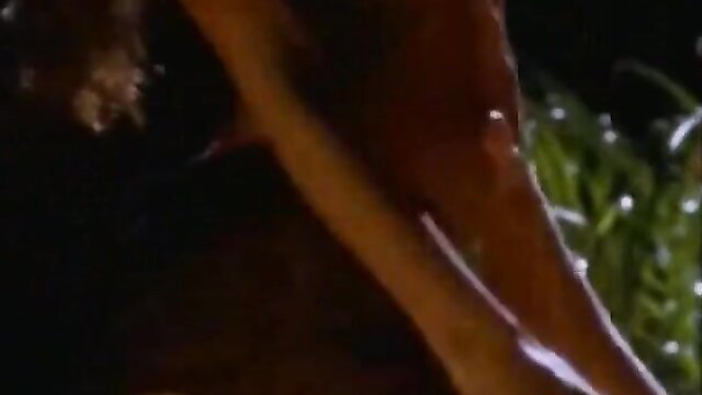 Blonde woman in wet sheer lingerie exposing curves in steamy softcore scene