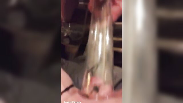 Clit choking closeup: huge cock stuffed in glass tube on pussy