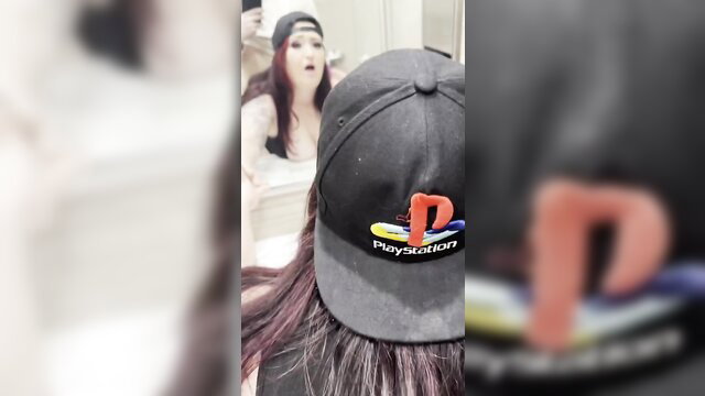Redhead babe in PlayStation cap poses topless in mirror selfie