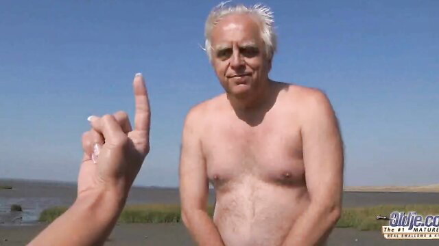 Old bald man nude on beach flips off camera, wild sex with busty girl