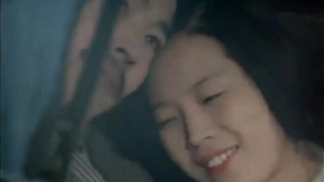 Asian woman smiling intimately in Japanese erotic movie candid scene