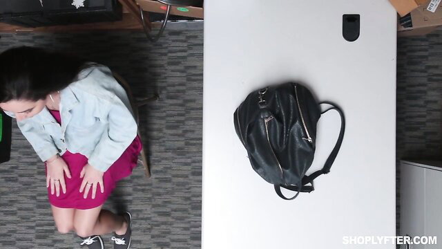 Karlee Grey kneels in red dress and denim jacket in Shoplyfter scene