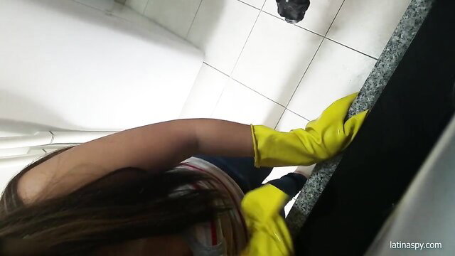 Latina maid in yellow gloves cleaning with wet cleavage exposed