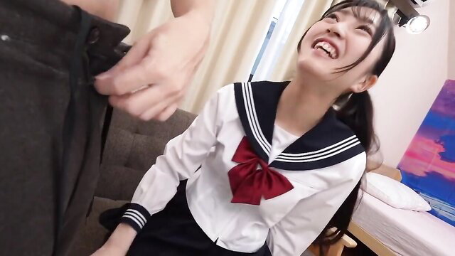 Japanese schoolgirl in sailor uniform grins as man gropes her hairy pussy upskirt