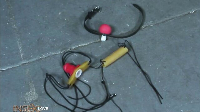 Insex Cowgirl Cowshow: red ball gag, leather collar, yellow dildo gag on floor