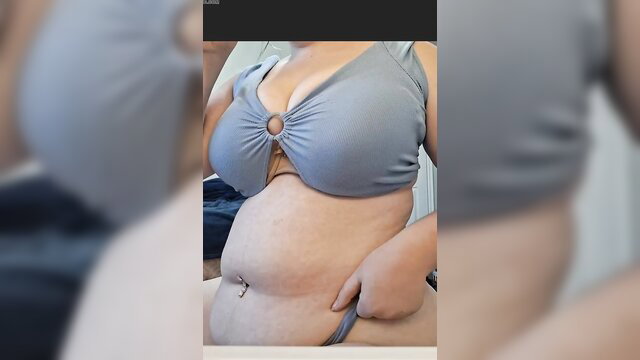 Curvy woman in gray ring bikini showing bloated belly and big tits