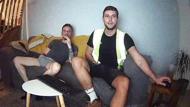 Two muscular English lads in hi-vis vests and shorts on couch
