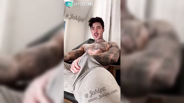 Jake Andrich tattooed hunk grabs bulging cock in grey sweats